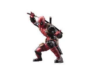 May include: A red and black action figure of Deadpool in a fighting pose, holding a katana sword. The figure is wearing a red and black suit with a black belt and a brown holster.