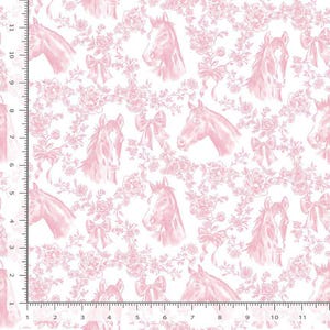 May include: A white fabric featuring a repeating pattern of light pink horse heads, floral arrangements, and bows. A ruler along the left and bottom edges shows the design scale, with markings up to 11 inches and 11 centimeters respectively.