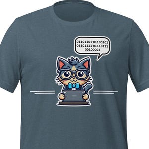 May include: A teal t-shirt with a cartoon cat wearing glasses and a bow tie, using a laptop. A speech bubble above the cat contains binary code. Two white lines are below the cat.