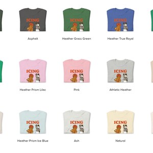 May include: A collection of t-shirts in various colors, each featuring the word "ICING" above a graphic of a bear and a referee. Colors include green, gray, blue, pink, and cream.