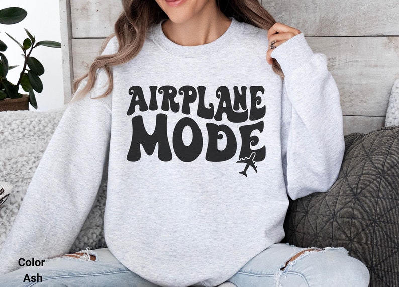 May include: A gray sweatshirt with the text "AIRPLANE MODE" in black, stylized lettering. A small airplane graphic is below the text.