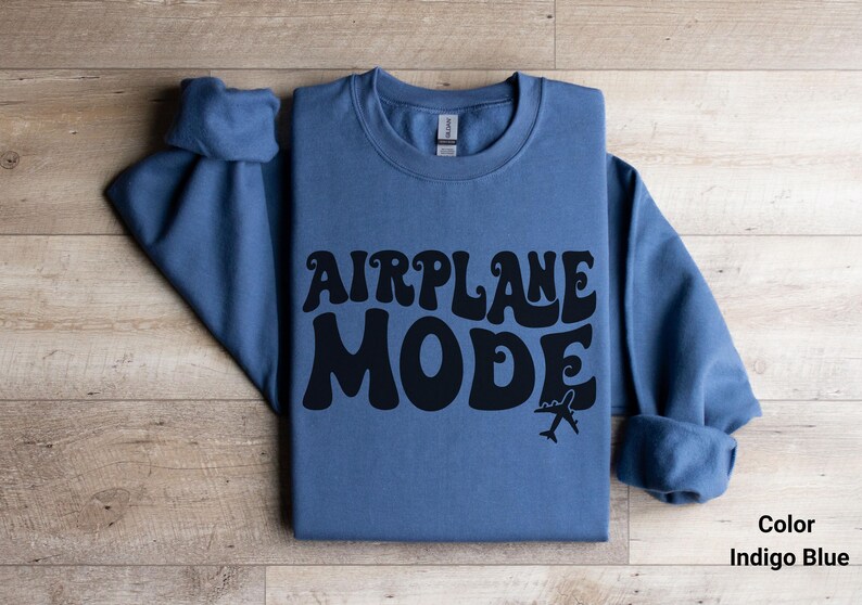 May include: Indigo blue sweatshirt with the text "AIRPLANE MODE" in black, stylized lettering. A small airplane graphic is below the text.