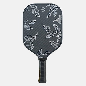 May include: A dark gray pickleball paddle with a white leaf design. The paddle has a textured surface and a black grip. The brand logo is visible at the top. The paddle is designed for sports and recreation.