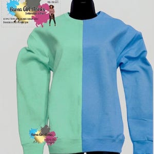 May include: A two-toned sweatshirt, split vertically with a light teal green on the left and a light blue on the right. The sweatshirt is displayed on a black mannequin. The text "Bama Girl Blanks" is visible.