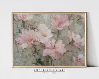 May include: A framed floral painting featuring soft pink and white flowers against a muted green background. The artwork has a textured, impressionistic style. The frame is a thin, gold color. The text "EMPORIUM PRINTS art collective" is at the bottom.