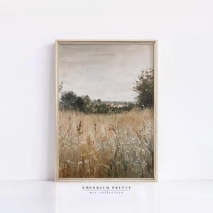 May include: A painting depicting a field of tall grass and wildflowers in front of a line of trees and a distant village. The sky is a soft grey with hints of pink and blue.