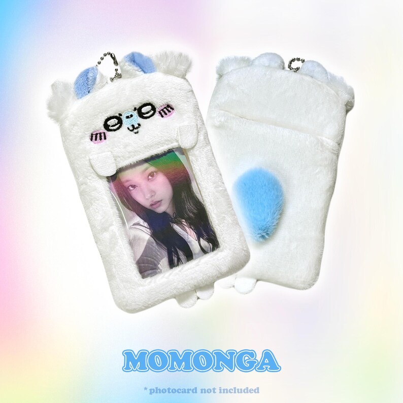 Momonga photocard holder in white plush with blue accents. Includes a fluffy tail detail and a transparent photocard display window, paired with a sturdy keychain by CottonKoko.