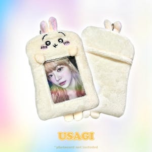 Usagi bunny photocard holder in cream-colored plush, featuring adorable pink ears and a transparent window for displaying cards or IDs. Includes a keychain by CottonKoko.