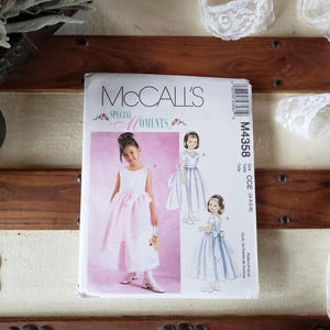 May include: McCall's Special Moments sewing pattern for a girl's dress. The pattern number is M4358 and the size is CC (3-4-5-6). The pattern includes three different dress styles.