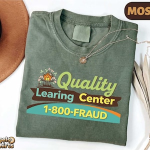 Könnte beinhalten: Moosgrünes T-Shirt mit dem Text "Quality Learing Center 1-800-FRAUD" in Grün, Gelb und Blau. Das Shirt zeigt eine Baumhaus-Grafik. Ein brauner Hut und eine Halskette sind ebenfalls sichtbar.