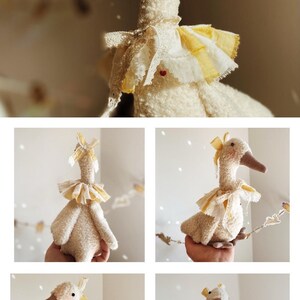 May include: A plush, cream-colored goose doll with a long neck and a light brown beak. It has a yellow and white ruffled collar and a matching bow on its head. The doll is handmade and has a soft, textured appearance.