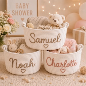 May include: Three round white woven rope baskets with handles, each personalised with embroidered names in cursive script and a small heart icon. The top basket reads Samuel, the bottom left reads Noah, and the bottom right reads Charlotte.