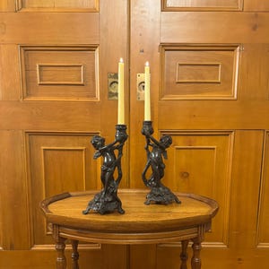 Pair of vintage 1960-1970’s made in Italy cast bronze putti (cherub) large candlestick holders.