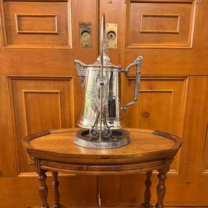Antique 19th century Victorian Aesthtic Movement Meriden Silver Co.  Quadruple plate silver plated tilting iced water pitcher on stand.
