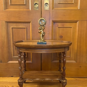 Antique ornate and very collectible cherub 24hr wind up mantle clock on a marble base.