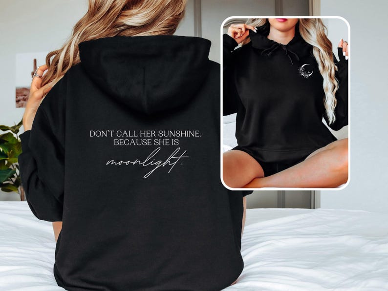 K&ouml;nnte beinhalten: Schwarzer Kapuzenpullover mit dem wei&szlig;en Schriftzug "DON'T CALL HER SUNSHINE. BECAUSE SHE IS moonlight.". Der Hoodie hat eine Kapuze und eine kleine Mondgrafik. Das Bild zeigt die R&uuml;ckseite und ein kleineres Vorschaubild.