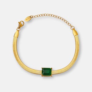 May include: A gold snake chain bracelet with a green square-shaped gemstone in the center.