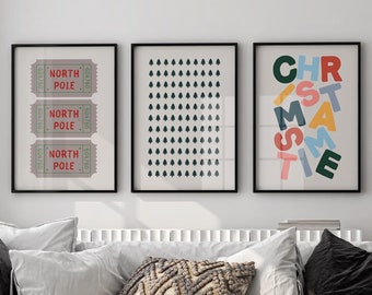 May include: A white couch with black and white throw pillows, a brown woven chair, and a marble coffee table. Three framed prints hang on the wall behind the couch. The prints feature a pattern of raindrops, the words "NORTH POLE" repeated three times, and the word "CHRISTMAS TIME" with each letter in a different color.