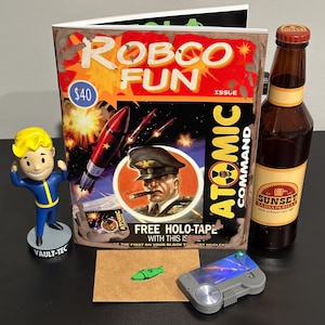 May include: A selection of Fallout-themed items: a "Robco Fun" magazine, a Vault-Tec figurine, a bottle of Sunset Sarsaparilla, and a grey device. The magazine has a retro design with rockets and a military figure. A green missile sticker and a small device are also present.