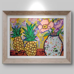 May include: A framed painting featuring two pineapples and a vase of flowers. The pineapples are yellow with green tops, and the vase is decorated with a floral pattern. The background is a mix of yellow, purple, and orange.
