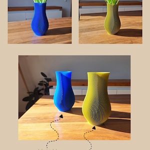 May include: Two 3D printed vases with a vertical ribbed texture, one in royal blue and one in olive green. The vases have a curved, tapered silhouette and are shown holding bouquets of pink tulips and white baby's breath flowers. Text reads by Japi Design.