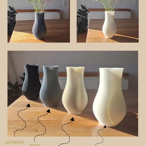 May include: A collection of four 3D-printed vases with a vertical ribbed, spiraling texture. The vases are available in black, gray, bone white, and white. Each vase features a narrow neck and a wider, rounded base, labeled as schwarz, grau, knochenwei&szlig;, and wei&szlig; by Japi Design.
