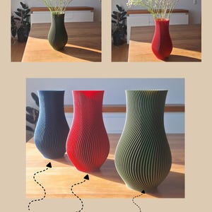 May include: Three vases with a vertical ribbed texture, available in dark blue, dark red, and dark green. The vases feature a tapered neck and a rounded body. The text "dunkelblau", "dunkelrot", "dunkelgr&uuml;n", and "by Japi Design" is visible.