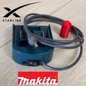 Könnte beinhalten: Ein blaugrüner Makita-Netzadapter mit einem grauen Stromkabel und einem roten Stecker. Der Adapter hat einen Netzschalter und ein Starlink-Logo.