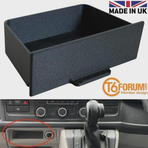 May include: A black, rectangular storage tray for a vehicle dashboard, with a textured finish. The tray has a front lip and is designed to fit into a dashboard compartment. The image includes "MADE IN UK" and the T6FORUM logo.