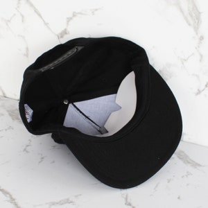 May include: A black baseball cap with a curved brim. The cap is made of a soft, cotton fabric and has a classic, casual style.