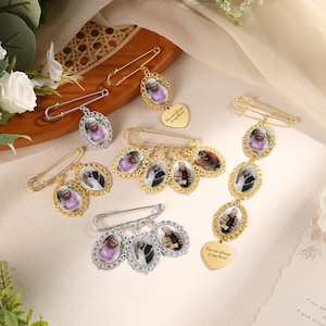 May include: A collection of memorial brooches with oval-shaped photo pendants. The brooches are in gold and silver tones, with decorative frames. Some have heart-shaped charms with the inscription "You are always in my heart."