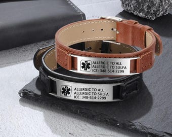 May include: Two leather medical alert bracelets with stainless steel plates. The top bracelet is brown leather with a silver plate that reads "ALLERGIC TO ALL ALLERGIC TO SULFA ICE: 348-514-2299". The bottom bracelet is black leather with a silver plate that reads "ALLERGIC TO ALL ALLERGIC TO SULFA ICE: 348-514-2299".