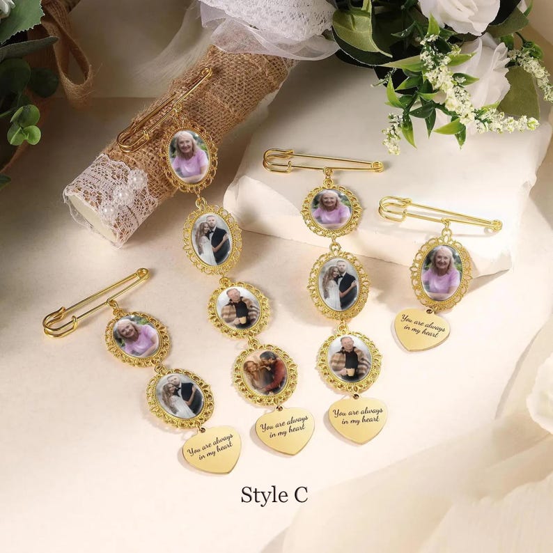May include: Gold-colored memorial brooch pins with oval photo frames and heart-shaped pendants. Each pin features a safety pin clasp and the text "You are always in my heart". The style is labeled "Style C".