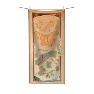 May include: A rectangular towel featuring a vintage-style map titled The World of Wine. The map displays various regions including France, California, and Australia in muted earth tones. A decorative border frames the map, which is suspended from a line.