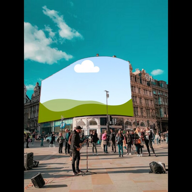 May include: A street musician plays guitar in a public square, with a large building featuring a landscape graphic in the background. People are gathered around, and the sky is blue with clouds.