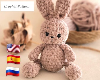 May include: Crochet pattern for a plush, light brown bunny. The bunny has a fluffy texture and black eyes. The pattern is available in English, Spanish, and Russian.