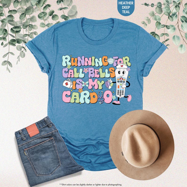 May include: A blue t-shirt with the text "RUNNING FOR CALL BELLS IS MY CARDIO" in colorful letters. A cartoon illustration of a nurse holding a remote control is next to the text.