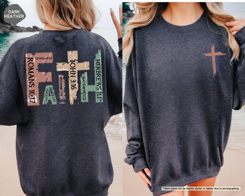 May include: Dark heather grey sweatshirt with a large graphic on the back. The graphic features a cross with the word "FAITH" written vertically in different colors. The cross is surrounded by bible verses, including Romans 10:17, Hebrews 11:1, John 3:16, Matthew 21:22, Proverbs 15:6, James 2:17, and Psalm 105:4.