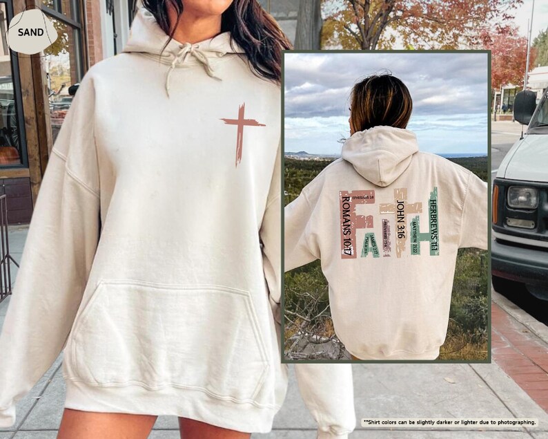 May include: A beige hoodie with a cross graphic on the front and the word "FAITH" spelled out with bible verses on the back. The hoodie has a drawstring hood and a kangaroo pocket.