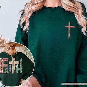May include: A dark green sweatshirt with a brown cross on the front and the words "FAITH", "ROMANS 10:17", "JOHN 3:16", "HERBREWS 11:1", and "MATTHEW" on the back.