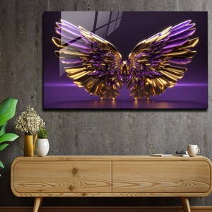 May include: A pair of gold and purple angel wings with a 3D effect, set against a purple background.