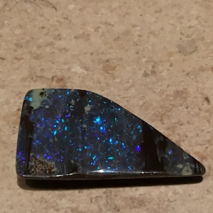 Blue and green night sky  pin fire pattern boulder opal.