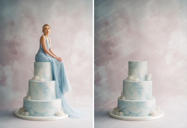 May include: A three-tiered cake with a light blue marble design, adorned with white floral accents. A person in a flowing blue gown sits atop the cake. The background features a soft, cloudy pink and gray backdrop.
