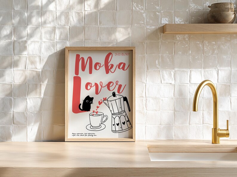 May include: A framed print with the words "Moka Lover" in red script. The image features a black cat, a coffee cup, and a moka pot with heart details. The background is a kitchen setting.