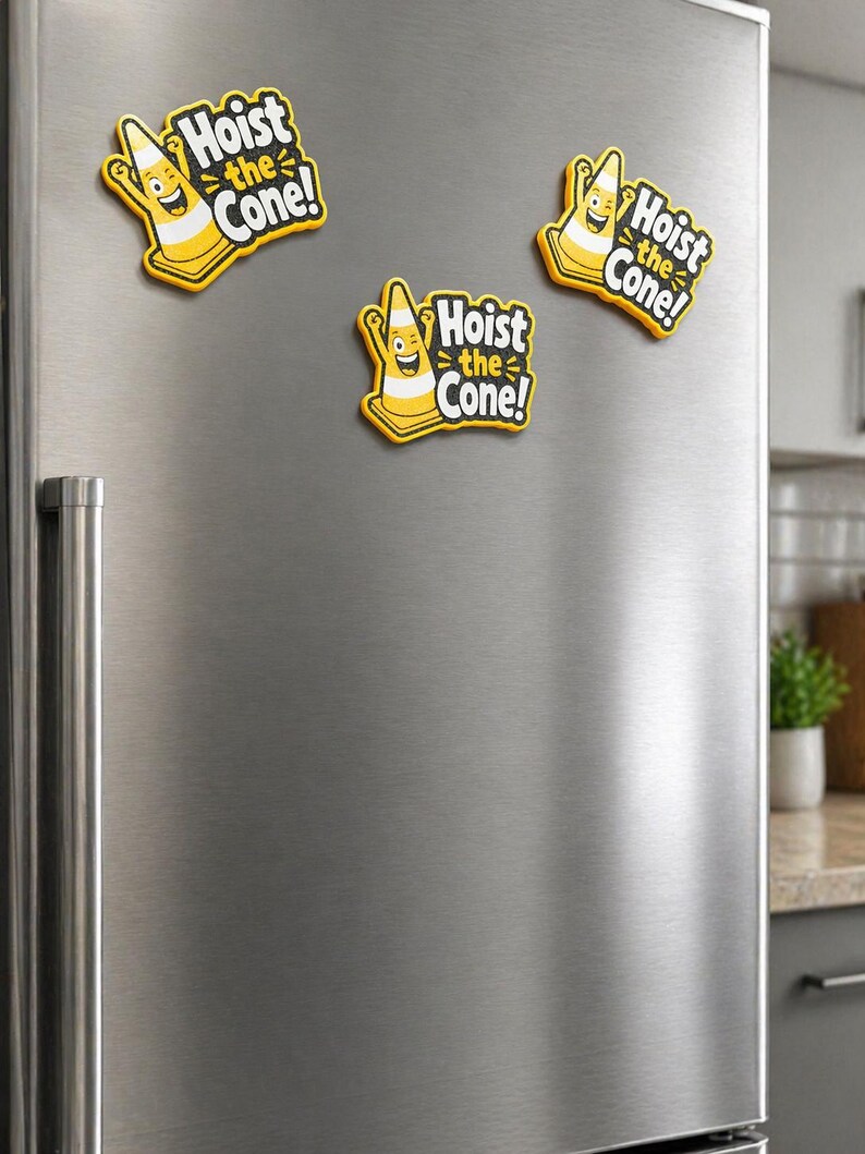 May include: Three yellow and black magnets with the text "Hoist the Cone!" are attached to a stainless steel refrigerator. Each magnet features a smiling traffic cone character.