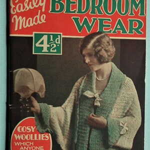 May include: A vintage magazine cover featuring a woman wearing a knitted cardigan. The cover reads "Easily Made Bedroom Wear" and "Cosy Woolies Which Anyone Can Make". The price is listed as "4 1/2d".
