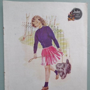 May include: Vintage illustration of a girl in a purple cardigan and pink skirt walking a dog. The image includes text that reads "Jersey, Cardigan and Socks for a girl of 12 to 14 years."