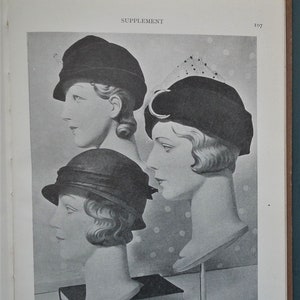 May include: Three mannequins with different hairstyles are wearing black hats. The hats are displayed on stands. The background is a white and black polka dot pattern.