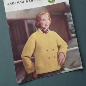 May include: A vintage magazine cover titled "Lavenda Hand Knit" featuring a woman wearing a yellow double-breasted jacket. The cover has a green and white graphic and the number 427. The woman is smiling and wearing a patterned scarf.