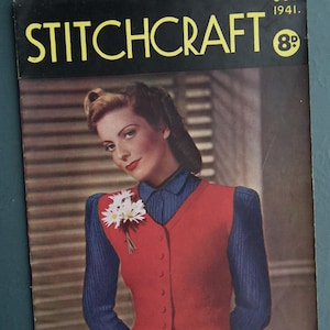 May include: Vintage magazine cover for Stitchcraft, October 1941. The cover features a woman wearing a red vest over a blue shirt, with a white flower corsage. The magazine title is in yellow, with the price in the upper right corner.